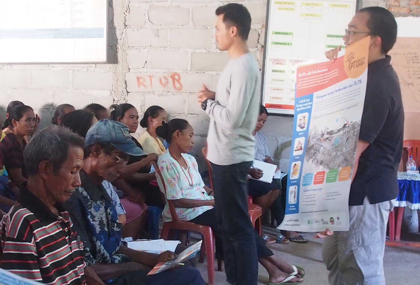 A community gathering for socialization, and using posters as visual aids.